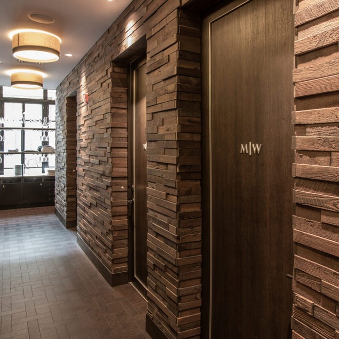 A restaurant hallway remodeled by custom millworkers from Seven Trees Woodworking