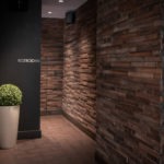 A brick entrance to a commercial spaces bathroom, remodeled by custom millworkers from Seven Trees Woodworking