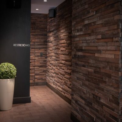 A brick entrance to a commercial space's bathroom, remodeled by custom commercial millworkers from Seven Trees Woodworking