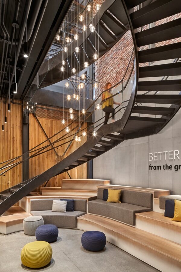 A staircase and lobby space remodeled by commercial millworkers from Seven Trees Woodworking