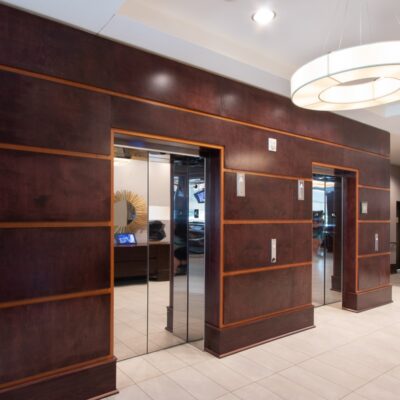 A wooden elevator opening remodeled by commercial millworkers from Seven Trees Woodworking