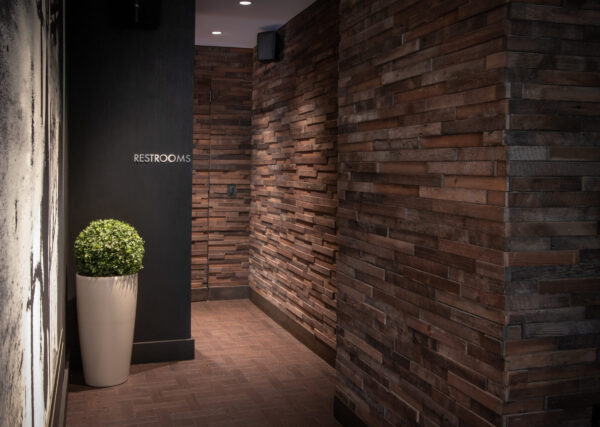 A brick pathway to a men's bathroom