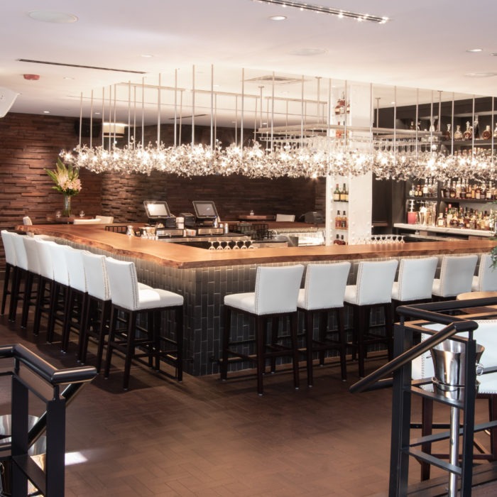 A raised top restaurant and bar remodeled by custom millworkers from Seven Trees Woodworking