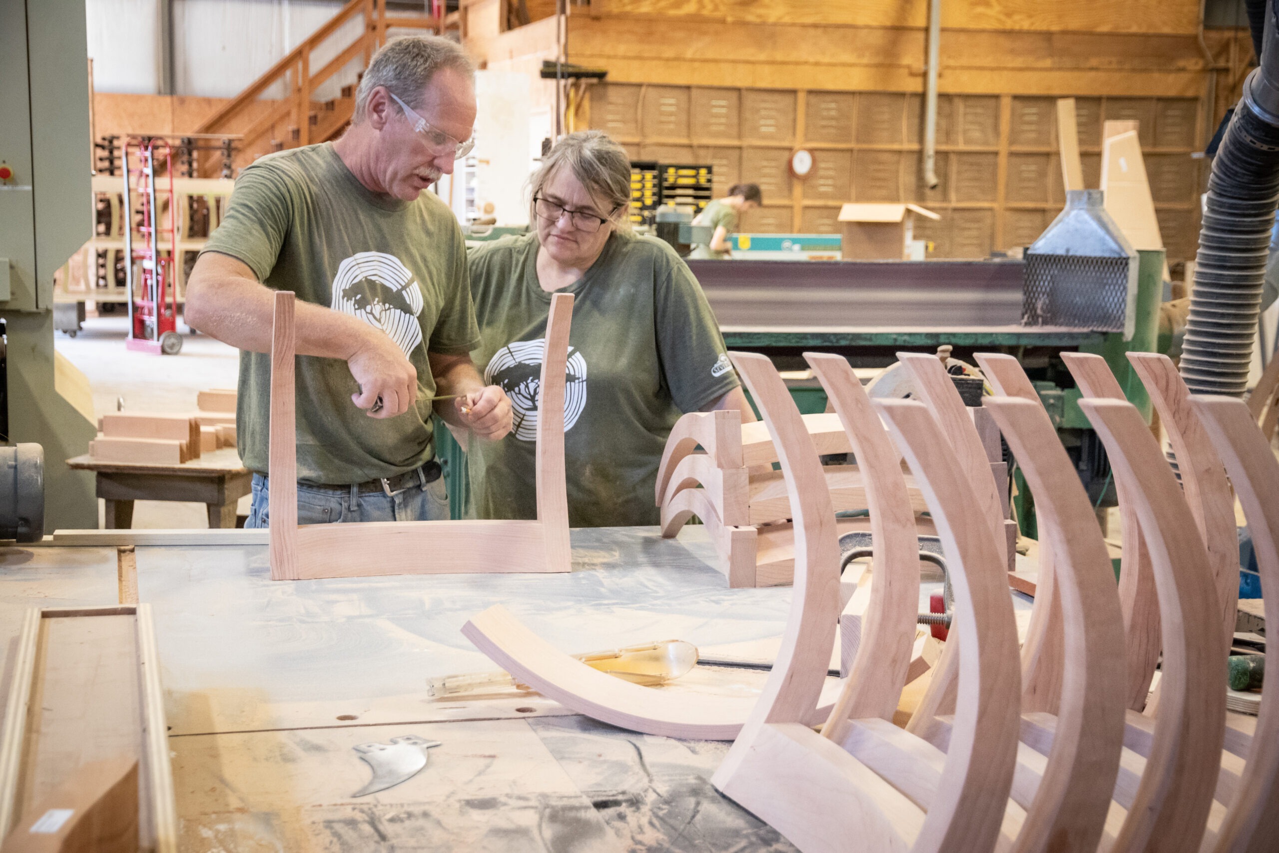 Seven Trees Woodworking employees working on chair legs